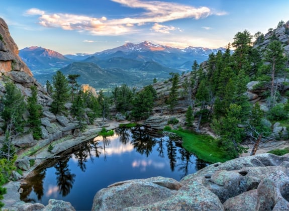 The last evening sunshine hits Longs Peak and The Crags above Gem Lake in Rocky Mountain National Park, Estes Park, Colorado