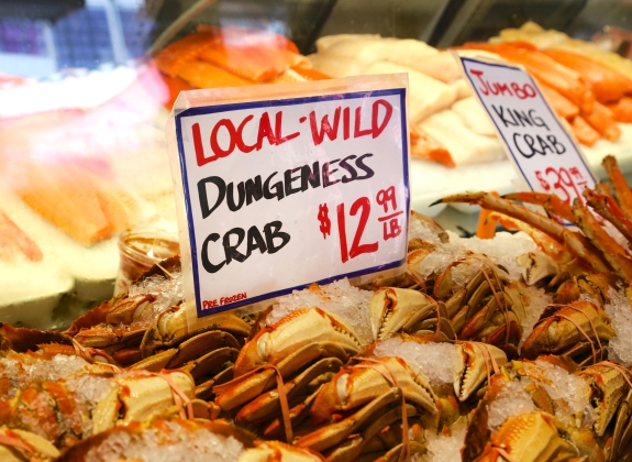 Dungeness Crab for sale with sign at Pike Place Market, Seattle