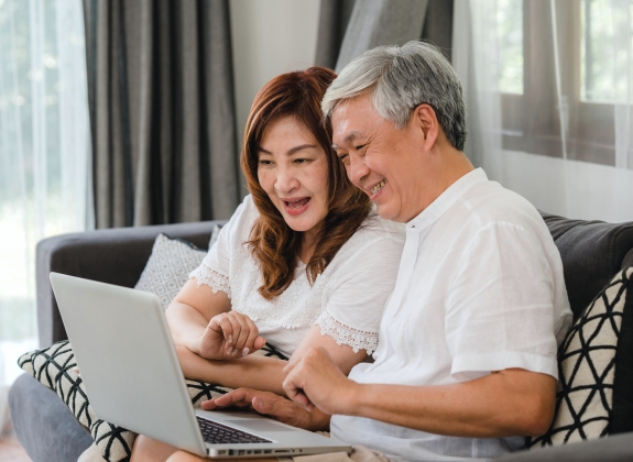 happy couple watching amtrak vacations webinar