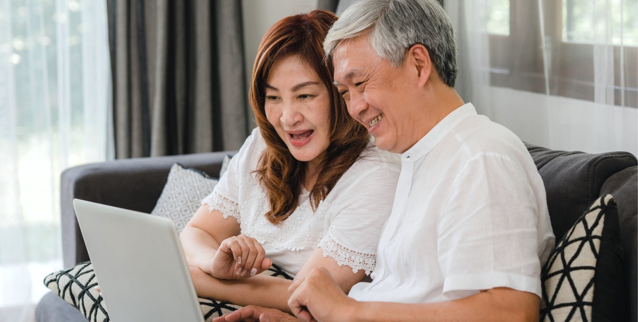 happy couple watching amtrak vacations webinar