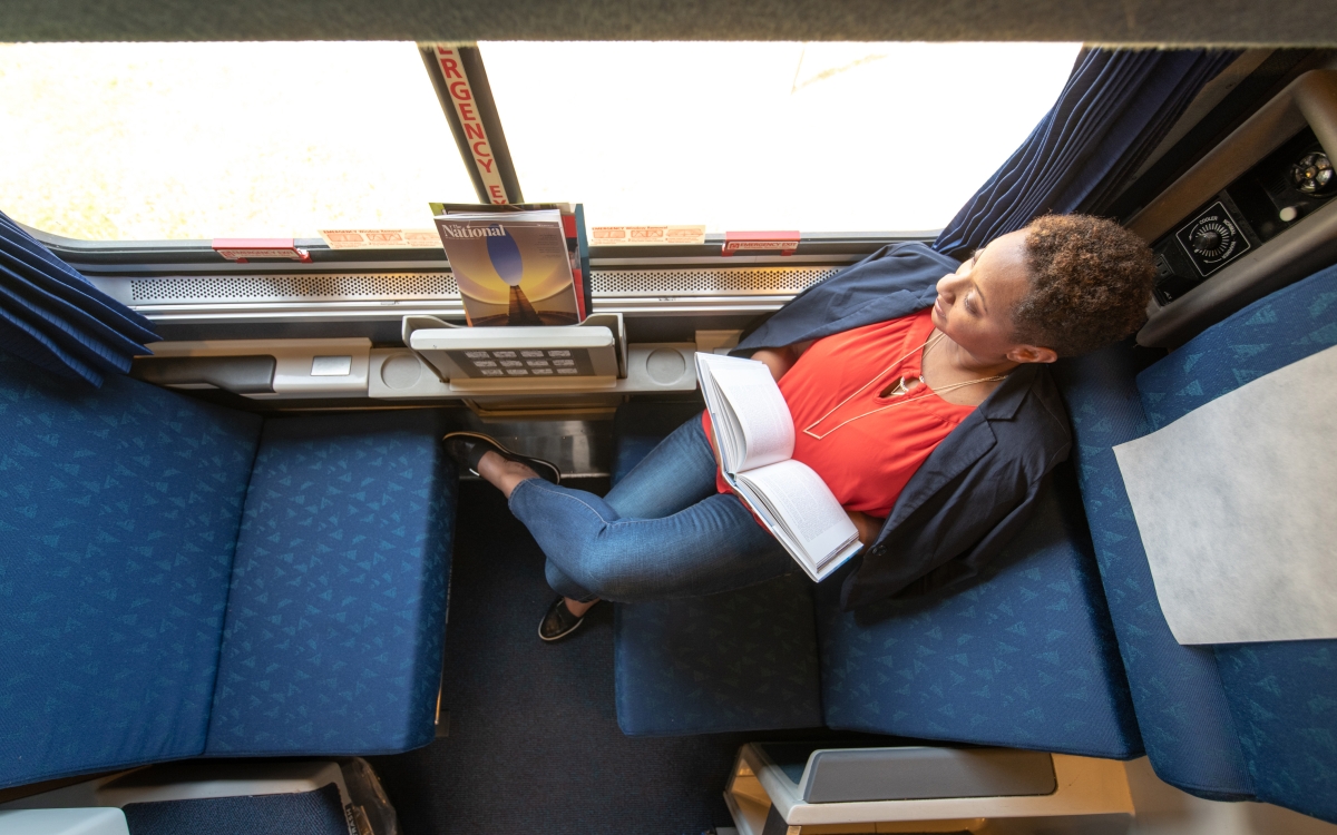 woman sitting in daytime layout of an Amtrak roomette
