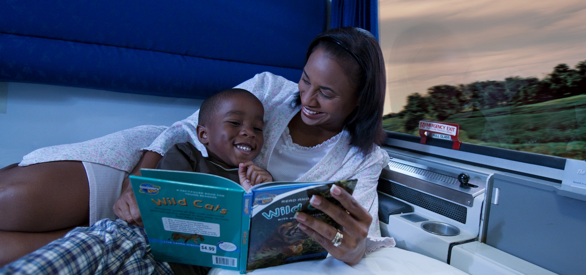 mom and child reading book in private room onboard amtrak