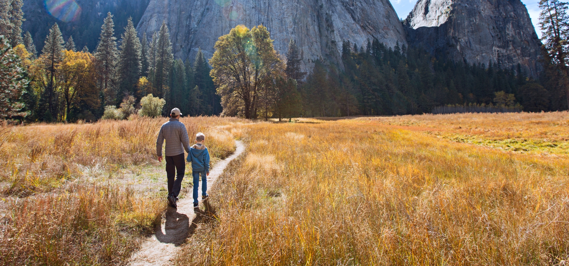 father and son walking el Capitan at Yosemite National Park