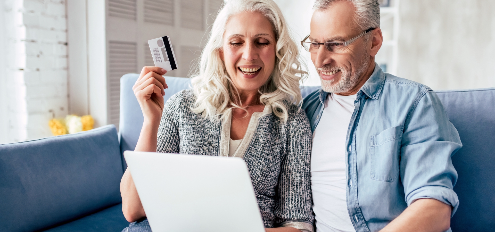 Mature couple looking at computer screen at home