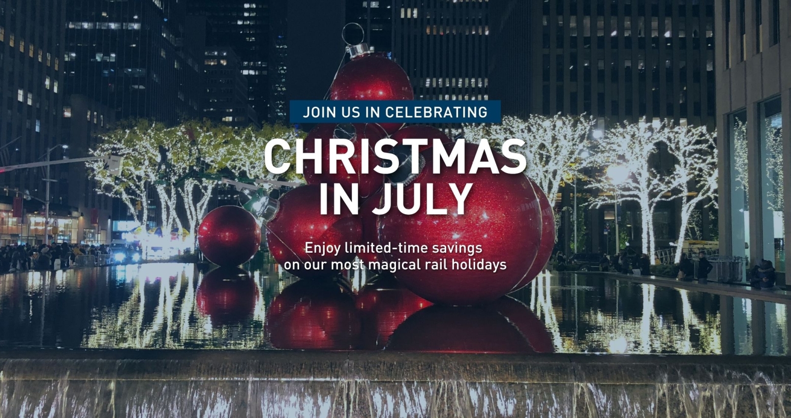 railbookers christmas in july featuring large decorative balls in a city fountain