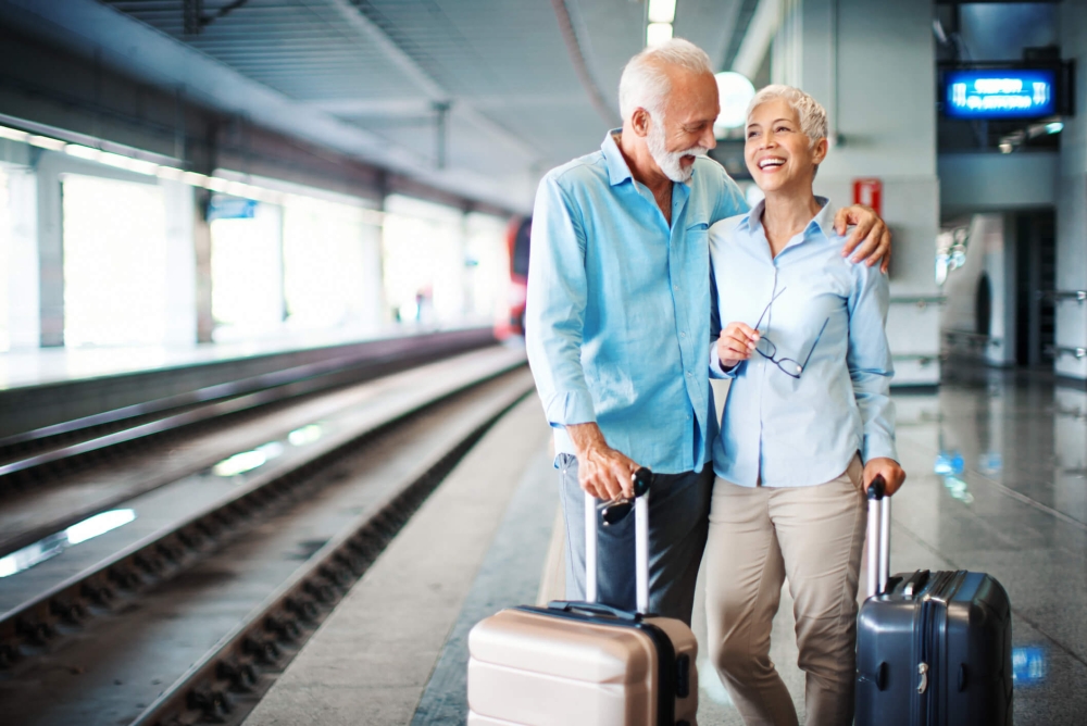 Couple with luggage at train station