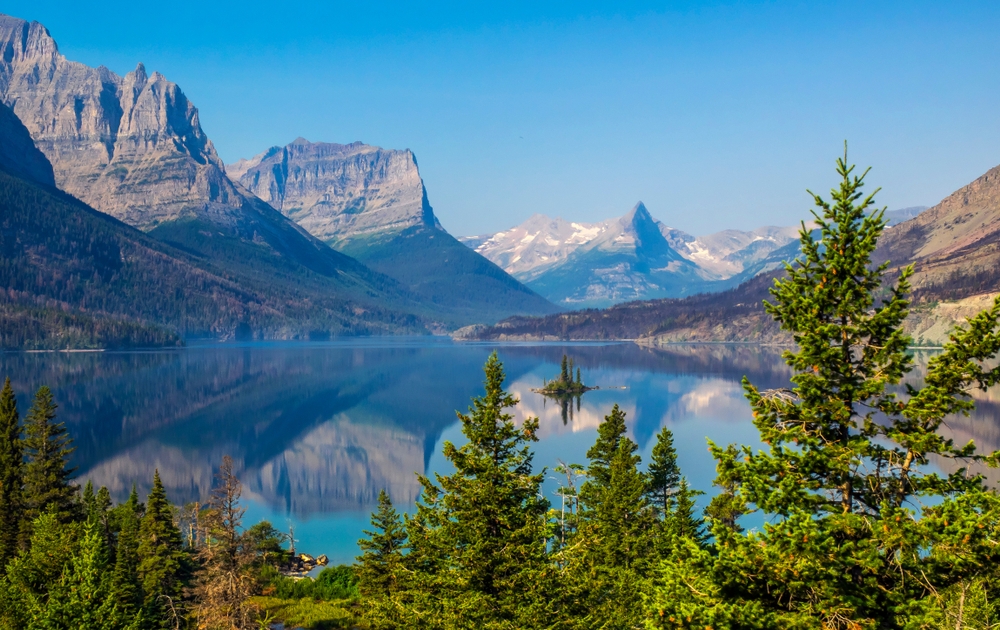 Goose Island in the middle of the St. Mary's lake with mountains peaks and reflection on background in Glacier National Park, Montana.